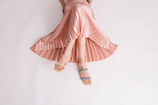 Elegant Pastel Pink Skirt with Stylish Sandals in Minimal Backgr
