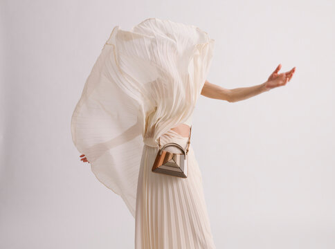 Elegant Flowing Pleated Dress with Artistic Accessory Detail in 