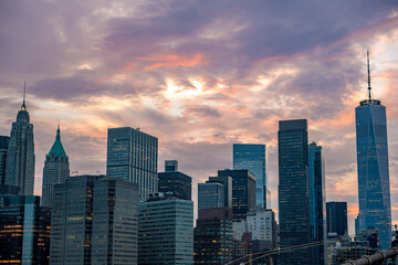 Manhattan skyline from Brooklyn Bridge at sunset.