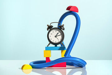 Alarm clock with colorful blue, yellow and red constructor blocks. 