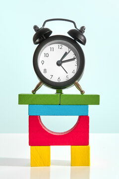 Alarm clock with colorful green, blue, yellow and red blocks. 