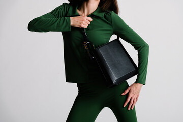 Person Showcasing Fashionable Handbag While Wearing Stylish Gree