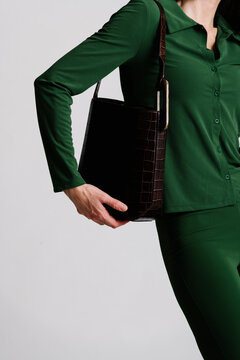 Stylish Close-Up of Crocodile Pattern Bag with Green Outfit