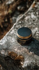Black and Gold Skincare Balm Jar on a Stone
