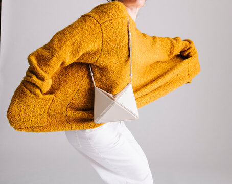 Yellow Sweater with Stylish Accessory in Modern Minimalist Style