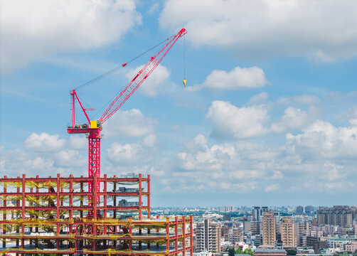 Red Crane Over Steel Building Construction Site