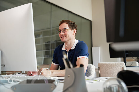 Man working at desk with computer in modern office