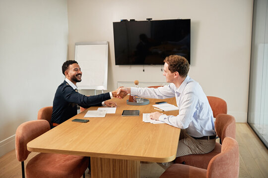 Business meeting with handshake in modern office setting
