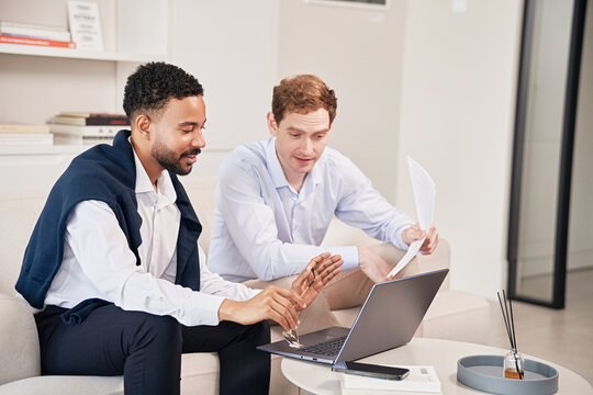 Young professionals collaborate on project in modern office