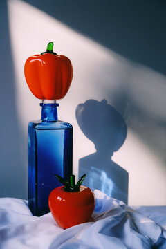 Colorful glass bottles with fruit-shaped decorations indoors