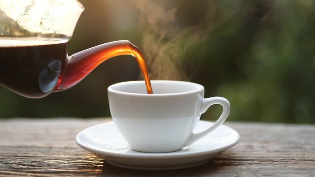 Hot coffee being poured into a white cup with steam rising, symbolizing warmth, energy, and relaxation. Perfect for cafe, breakfast, beverage, or morning lifestyle concepts.