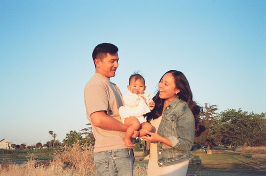 parents holding baby together