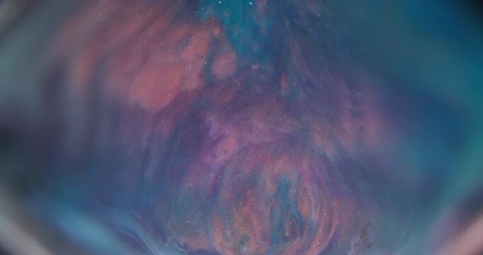 Blur colorful splash. Acrylic wave. Defocused orange blue purple paint sparkling pigment spreading on abstract creative background.