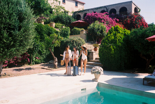 Tourists arriving at hotel with swimming pool