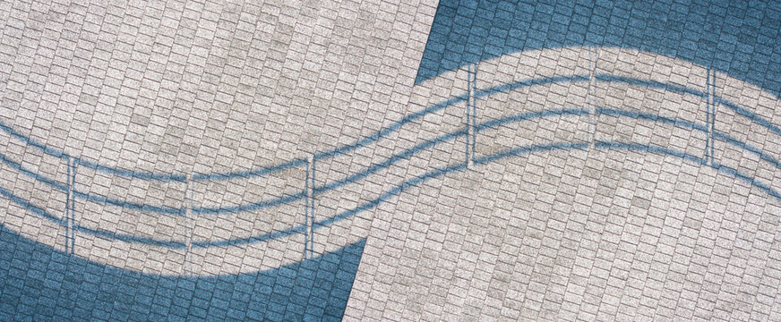 Wavy Fence Shadows on Textured Building Surface
