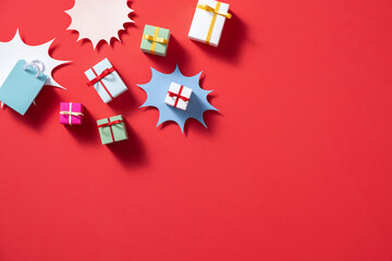 Colorful Gift Boxes on Bright Red Background with Starbursts