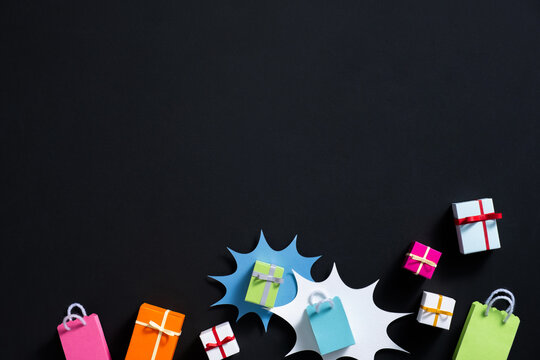 Colorful Gift Boxes On Black Background With Shopping Bags