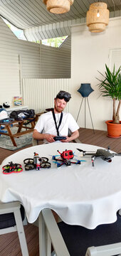 FPV pilot preparing drones on terrace