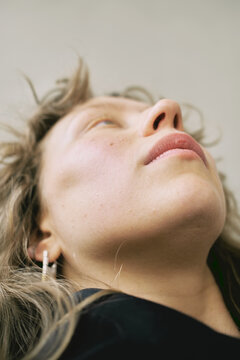 Woman gazing upward with natural light illuminating her face