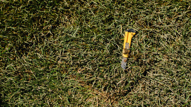 Utility knife on grass