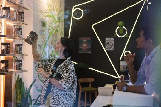 Customer browse cannabis products in a modern dispensary setting.
