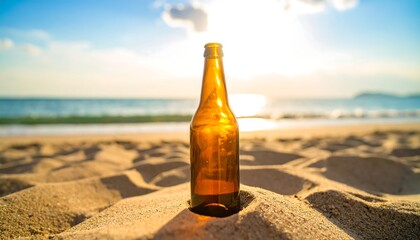 Empty beer bottle on beach sand