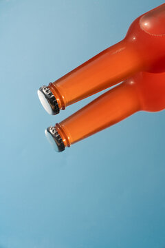 Red glass bottle with reflection on blue background