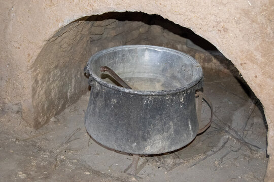 Rustic Cooking Pot in a Traditional Mud Brick Fireplace Setting