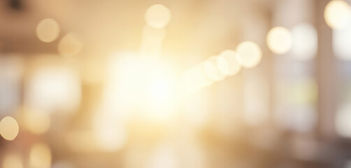 Abstract blurred background with delicate bokeh lights in warm golden and beige tones, creating an elegant and softly glowing atmosphere.