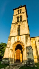 Fototapeta premium Ancient church tower in sunlight