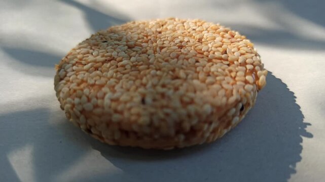 Delicious sesame seed biscuits with a crispy texture and rich nutty flavor, served on a wooden plate. Healthy snack option made with natural ingredients, perfect for a nutritious treat