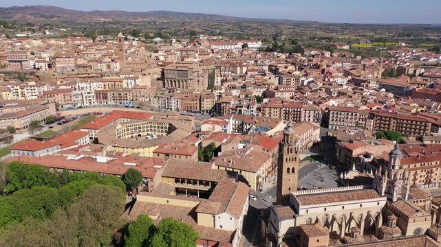 Drone view of historical part of Tarazona city with ancient bullfight arena and medieval cathedral with seminary on sunny spring day, Spain