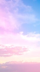 A serene pink sky at dusk, adorned with soft, fluffy clouds that reflect shades of lavender and peach, creating a tranquil and dreamy atmosphere.