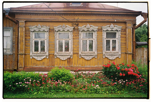 Beautiful wooden house with intricate window frames and  flower