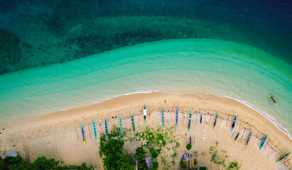 Scenic island harbor with traditional boats and turquoise sea.