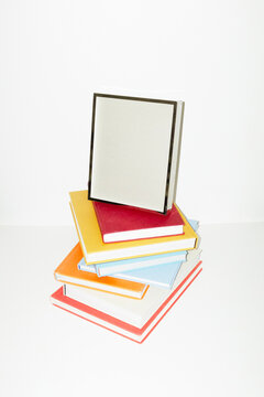 Silver photo frame on top of book pile in work office business desk