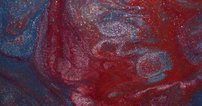 Vibrant splash. Shiny ink wave. Defocused red blue silver color sparkling texture spreading on abstract acrylic creative background.