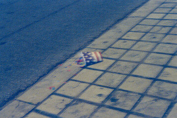abandoned usa cup on pavement at night, 35mm