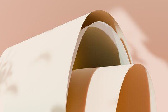 Abstract 3D wave-like curves casting soft shadows on beige background