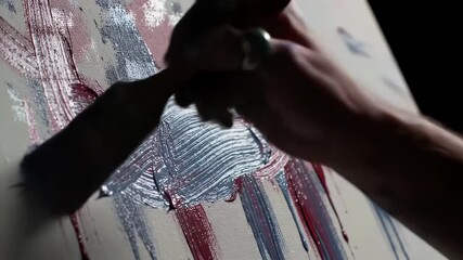 Time-lapse of an artist's hands applying fluid strokes of red, white, and blue paint to create dynamic modern abstract art on canvas using a brush, - Powered by Adobe