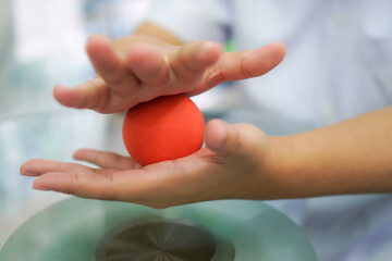 Close-Up of Hand Therapy Using Red Stress Ball