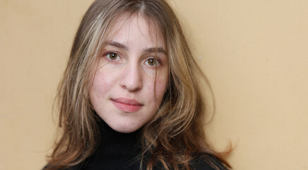 Portrait of a young girl near the wall close-up.