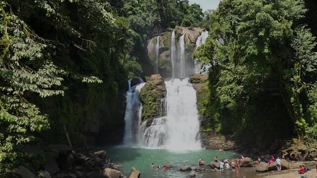 Nauyaca Waterfall drone aerial footage. Perez Zeledon beautiful waterfall with tourists enjoying the water. 