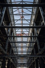 Steel construction framework of modern industrial building under development, structural metal beams and architecture engineering background for construction, infrastructure, and industry