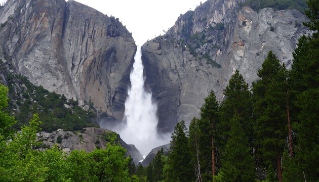 Majestic waterfall cascading between granite cliffs
