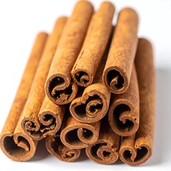 A close-up shot of a stack of cinnamon sticks against a white background
