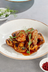 Pork medallions with sweet chili sauce and grilled potatoes, bright lighting, overhead composition