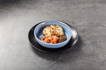 Salmon tartare with ciabatta and olive tapenade, bright rustic lighting, minimal overhead composition