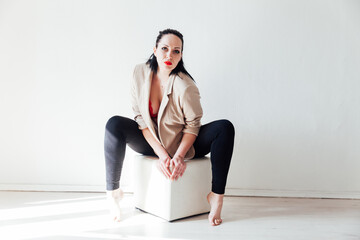 woman in jacket and red bra on white background