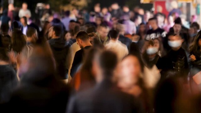 Timelapse Crowd of People Walking a Busy Street at Night. People in Motion Blur and Vibrant Town Atmosphere. Representing Urban Life and Activity Video Showing a Large Group Persons Along Outdoor 4k